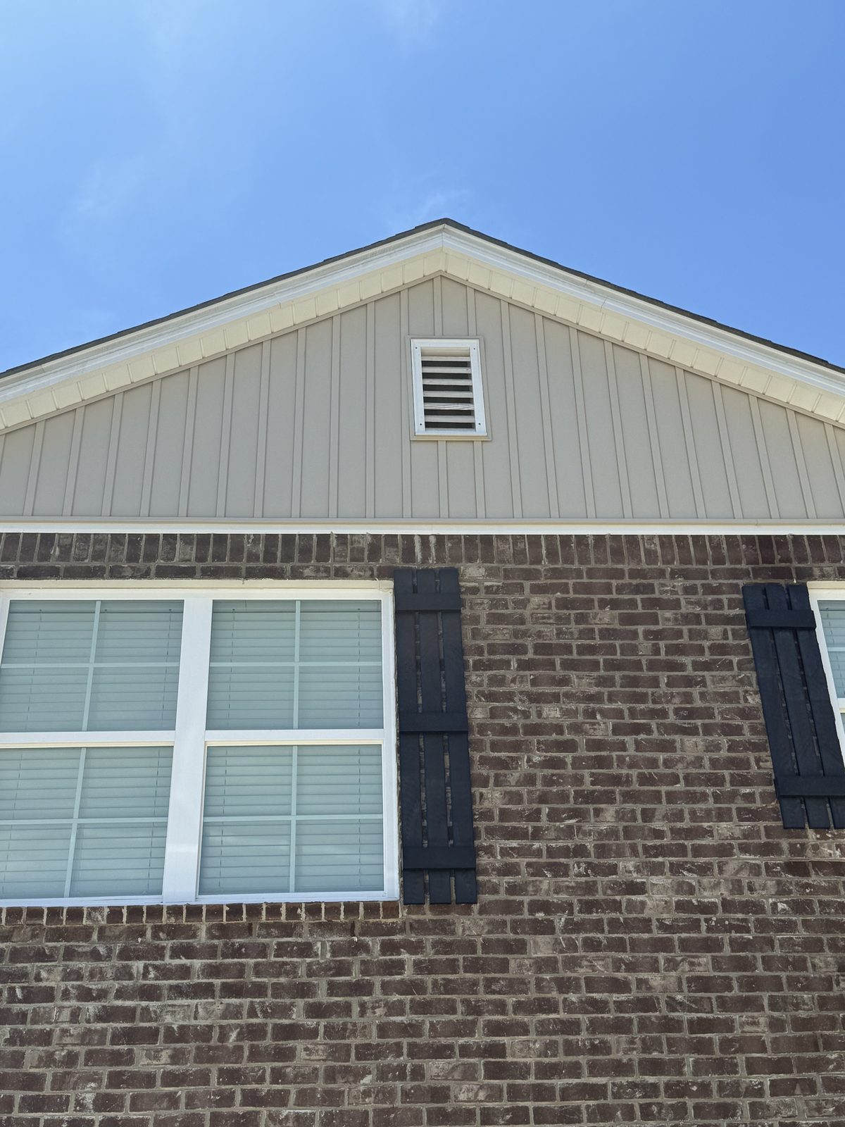 After - Clean board and batten siding and brick exterior after soft wash